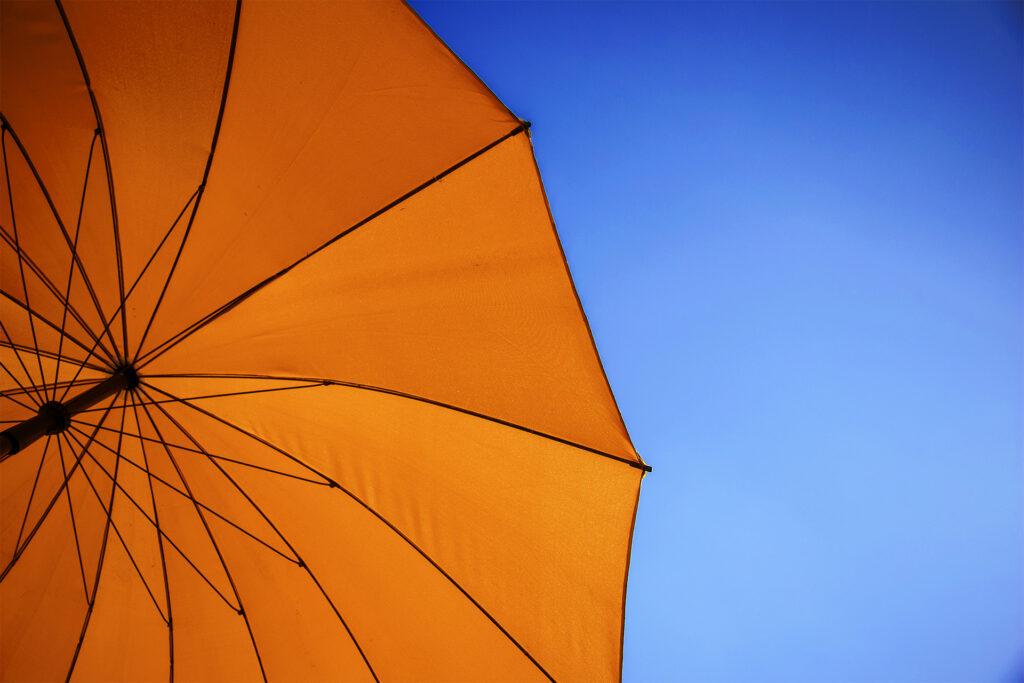 orange parasol under blue sky